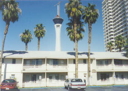 Pic facing north of the stratosphere tower behind wooden buildings to be razed